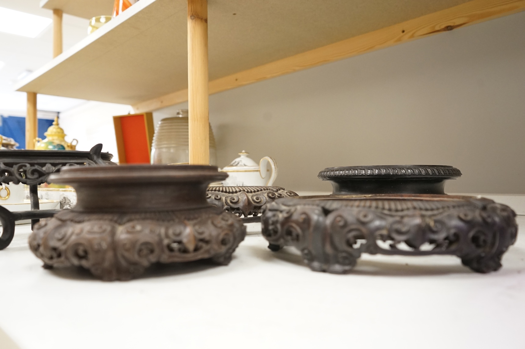 A collection of five Chinese and Japanese carved hardwood stands, late 19th/early 20th century, largest 25cm in diameter